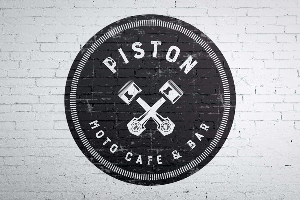 Piston Moto Cafe Painted Logo on Brick Wall